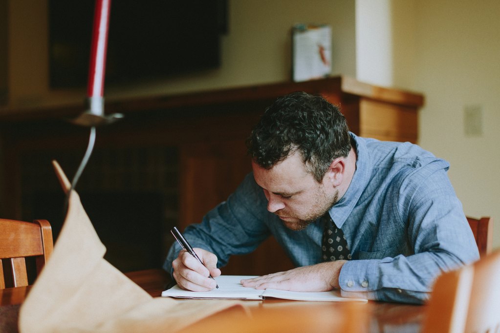 Groom writing letter to bride