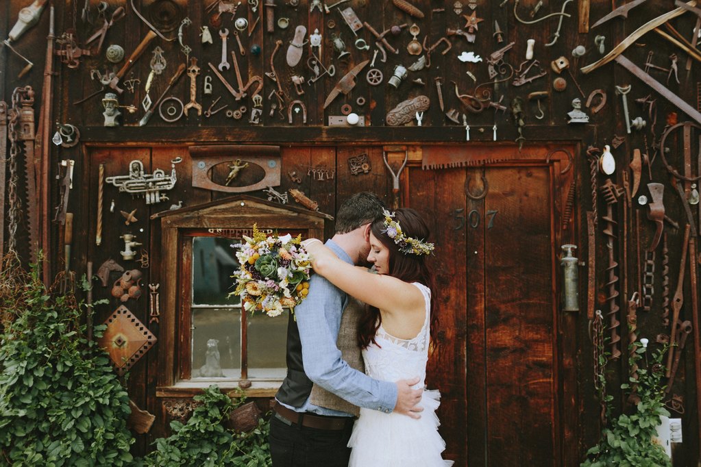 Bride and groom in front of barn in Crested Butte