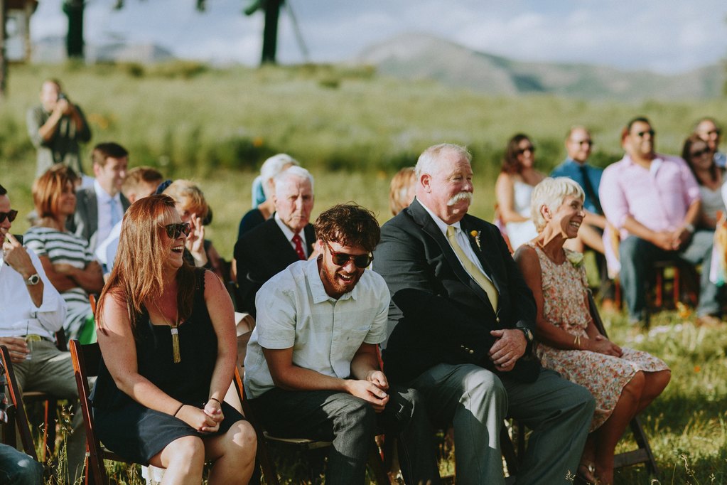 guests laughing during joke at wedding ceremony
