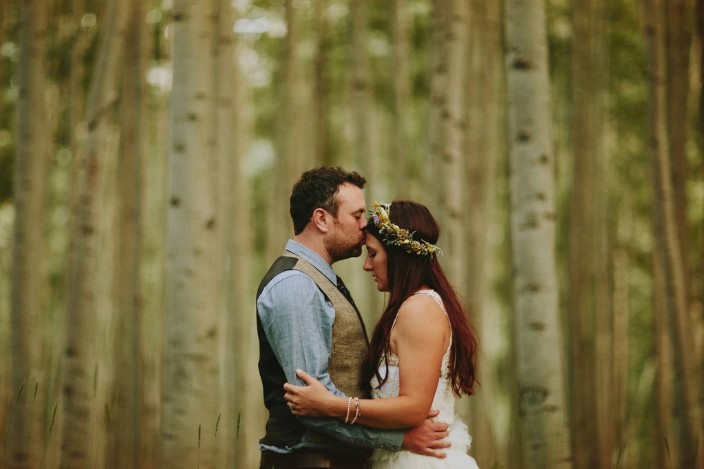 Bride and groom in aspen trees